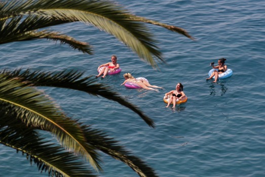 Girls have a swim in the Mediterranean sea, in Nice, southeastern France.