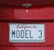 A license plate is displayed on a Tesla Motors Inc. Model 3 vehicle outside the company's Gigafactory in Sparks, Neveada.