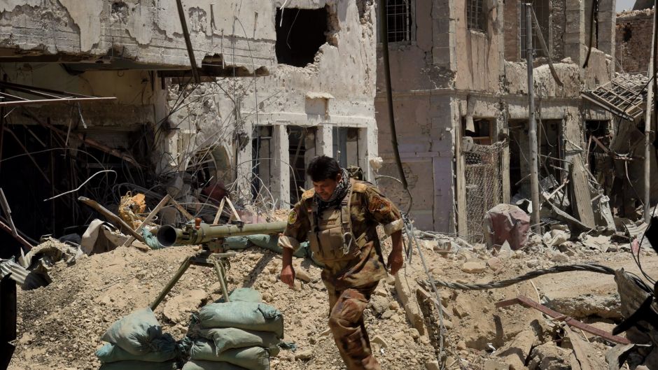 Lieutenant Colonel Saaed Beder Kathem moves away from the blast range of a planned detonation of one of six IEDs on a ...