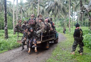 A new group of armed members of Moro Islamic Liberation Front, a Muslim rebel group which signed a 1996 peace pact with the Philippine Government arrive at Patikul township, on the volatile island of Jolo in southern Philippines Tuesday Jan. 15, 2013