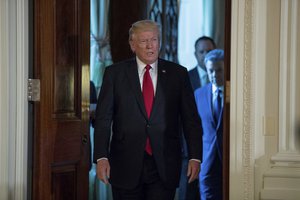 President Donald Trump accompanied by Colombian President Juan Manuel Santos, right, arrives for a news conference in the East Room of the White House, Thursday, May, 18th, 2017, in Washington.