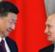 Russian President Vladimir Putin, right, and Chinese President Xi Jinping attend a signing ceremony following their ...