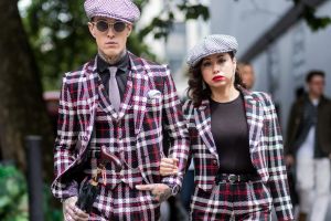 LONDON, ENGLAND - JUNE 12: Couple Jimmy Q and Jet Luna wearing flat cap and checked suits during the London Fashion Week ...