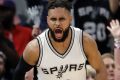 San Antonio Spurs guard Patty Mills (8) celebrates sinking a basket in front of Houston Rockets' Patrick Beverley (2) ...