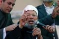 February 2011: Yusuf al-Qaradawi speaks to the crowd at Friday prayers in Tahrir Square in Cairo. 