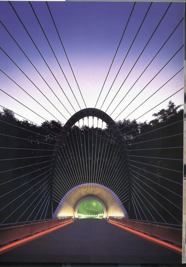 A suspension bridge frames the tunnel leading out of the Miho Museum.