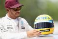 Chasing legends: Lewis Hamilton with a commemorative helmet of F1 legend Ayrton Senna after matching his record 65 pole ...