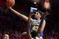 Jonah Bolden of the UCLA Bruins shoots over Kadeem Allen of the Arizona Wildcats during a college basketball game in ...