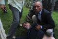 A bodyguard watches over opposition lawmaker Americo De Grazia, who was injured in a melee with pro-government militia ...