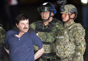 FILE - In this Jan. 8, 2016 file photo, Joaquin "El Chapo" Guzman is made to face the press as he is escorted to a helicopter in handcuffs by Mexican soldiers and marines at a federal hangar in Mexico City, Mexico,