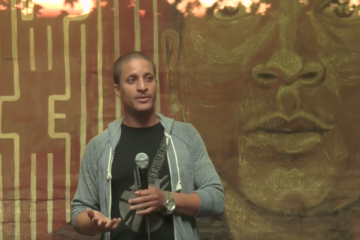 Akeem Browder, founder of Shut Down Rikers Island, speaks in front of a mural for his brother, Kalief Browder. Screenshot from YouTube user Peter Eliscu: https://www.youtube.com/watch?v=QndE6jOSU9g