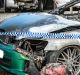 Police examine a property in Kambah after shots were fired and vehicles set alight on Friday morning in what police are ...