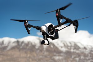 Drone camera black and white quad copter flying during day time