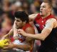 Fan favourite: First-year defender Lewis Melican of the Swans marks in front of Tom McDonald of the Demons.