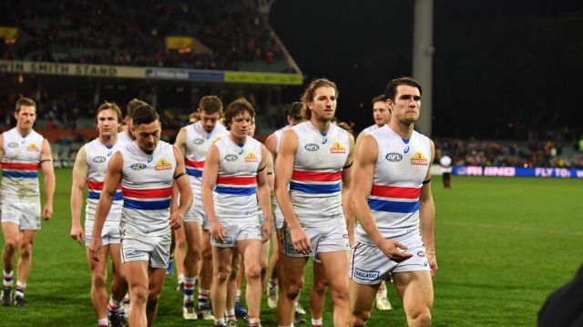 Shellshocked: The Bulldogs walk off the field after a thumping at Adelaide Oval.