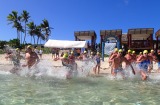 Ocean Swim Safari participants take the plunge into the warm waters of Mana Island, Fiji.