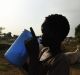 A boy drinks fresh milk at the cattle camps that have popped up on the outskirts of Bentiu in South Sudan.