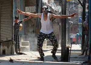 Kashmiri protestors clash with Indian police in Srinagar, the summer capital of Indian Kashmir, 8 July 2017. Authorities imposed curfew in some parts of Kashmir and large numbers of troopers were deployed to prevent protests on the anniversary of Hizbul Mujahideen Commander Burhan Muzaffar Wani's death.