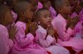 Young Buddhist nuns pray at the famed Shwedagon Pagoda during the Full Moon of Waso, Saturday, July 8, 2017, in Yangon, ...