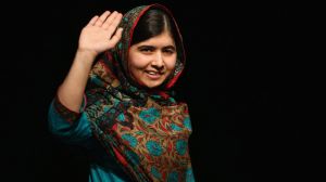 Malala Yousafzai waves to the crowd at a press conference at the Library of Birmingham after being announced as a ...