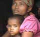 Four-year-old Rosmaida Bibi, who suffers from severe malnutrition, with her mother Hamida Begum's lap. She cannot grow ...