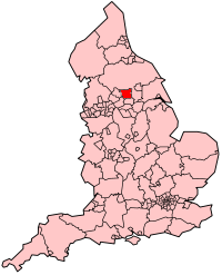 A map of England coloured pink showing the administrative subdivisions of the country.  The Leeds metropolitan borough area is coloured red.