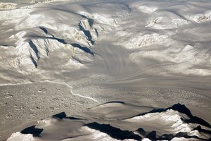 File - Glaciers and mountains in the evening sun are seen on an Operation IceBridge research flight, returning from West Antarctica on Oct. 29, 2014.  The mission also plans to collect data in portions of the Antarctic Peninsula, such as the Larsen C, George VI and Wilkins ice shelves and the glaciers that drain into them. The Antarctic Peninsula has been warming faster than the rest of the continent.