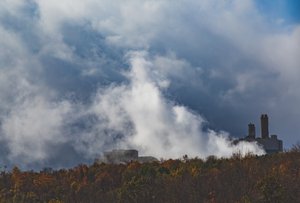 An industrial plant smoke gas rise in the air causing air pollution in Ebensburg, Pennsylvania, as seen from US Route 22