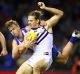 Nat Fyfe of the Dockers is tackled by Trent Dumont of the Kangaroos during Sunday's match at Etihad Stadium.