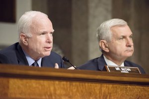 File - U.S. Sen. John McCain, left, chairman of the Senate Armed Services Committee, questions Defense Secretary Ash Carter and Army Gen. Martin E. Dempsey, chairman of the Joint Chiefs of Staff, during a hearing in Washington, D.C., on the strategy to counter the Islamic State of Iraq and the Levant, July 7, 2015.