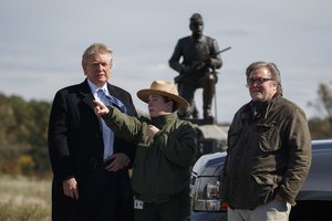 File - Interpretive park ranger Caitlin Kostic, center, gives a tour near the high-water mark of the Confederacy at Gettysburg National Military Park to Republican presidential candidate Donald Trump, left, and campaign CEO Steve Bannon, Saturday, Oct. 22, 2016, in Gettysburg, Pa.