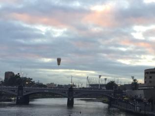 Air balloon drifts over the Yarra River at Southbank this morning.