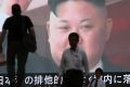 People walk past a TV screen showing an image of North Korean leader Kim Jong-un  on Tuesday.