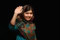 Malala Yousafzai waves to the crowd at a press conference at the Library of Birmingham after being announced as a ...