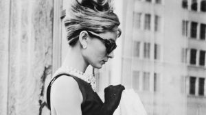 June 1961: Audrey Hepburn (1929 - 1993) stops for lunch on Fifth Avenue in New York during location filming for ...