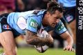 High intensity: Mitchell Pearce crosses the line for the Blues in Origin I this year.