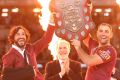 Johnathan Thurston and Cameron Smith of the Maroons hold aloft the Origin trophy.