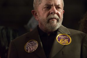 Brazil's former President Luiz Inacio Lula da Silva listens as Rio de Janeiro mayoral candidate Jandira Feghali speaks during a rally in Rio de Janeiro, Brazil