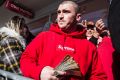 Large wads of cash are passed around by the people waiting in the queue to buy fashion from the Louis Vuitton x Supreme ...