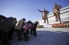 North Koreans bow on Mansu Hill, where bronze statues of late leaders Kim Jong Il and his father, Kim Il Sung, in ...