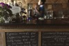 A waitress works behind the counter at the Kumrung cafe where the menu includes the usual favourites of customers in the ...