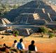 Visitors look toward the Pyramid of the Moon, from a vantage point at the top of the Pyramid of the Sun, during ...