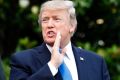 US President Donald Trump answers a question as he walks to Marine One, the presidential helicopter, on Wednesday.