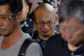 A protester cries as he mourns jailed Chinese Nobel Peace laureate Liu Xiaobo during a demonstration outside the Chinese ...