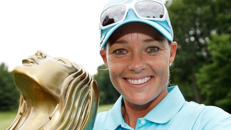 Katherine Kirk  imitates a "selfie" as she poses with the championship trophy after winning the Thornberry Creek LPGA ...