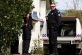 Police at the Bulimba townhouse earlier this month.