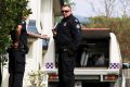 Police at the Bulimba townhouse earlier this month.