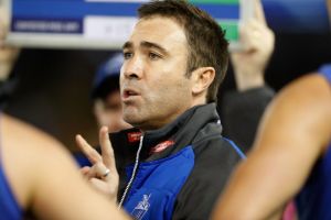 Through and through: Kangaroos coach Brad Scott talks to his players.