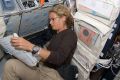 Julie Payette reads a procedures checklist on Endeavour during flight day two activities.