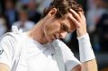 Defending champion Andy Murray leaves the court after a shock loss to Sam Querrey.